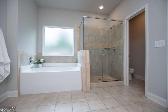 bathroom featuring a shower stall, a garden tub, tile patterned flooring, toilet, and recessed lighting