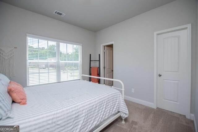 carpeted bedroom with baseboards