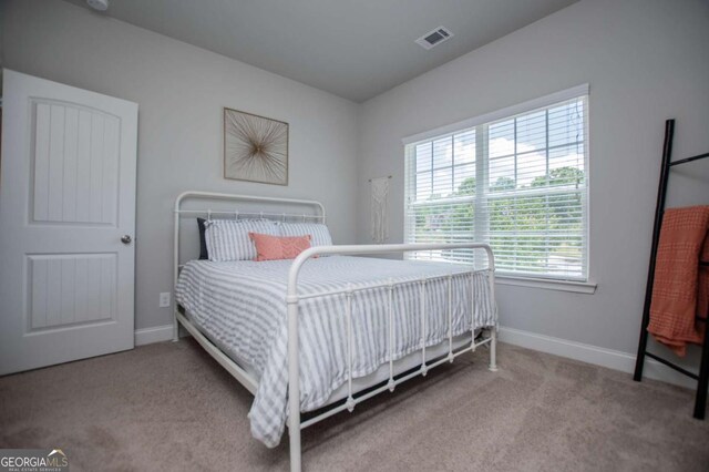 bedroom featuring carpet and baseboards
