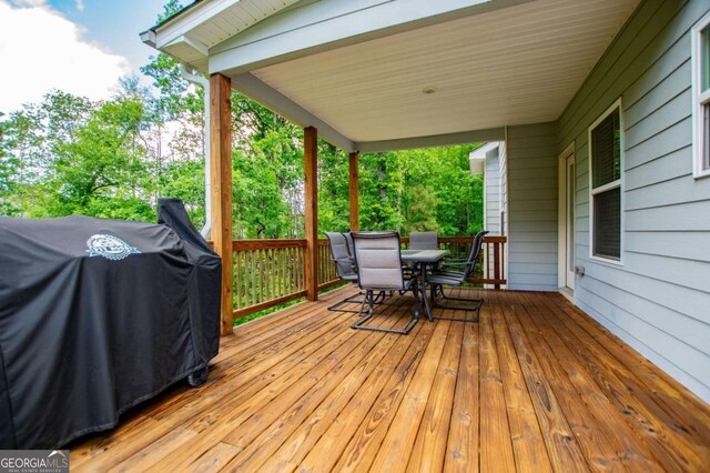 rear view of house featuring a wooden deck, a lawn, and stairway