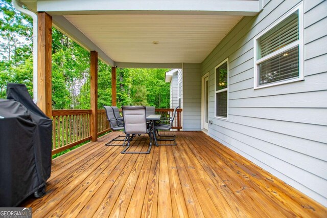 view of side of property with a yard, a deck, and central AC unit