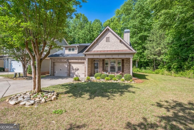 view of front facade with a chimney, driveway, a front lawn, an attached garage, and covered porch