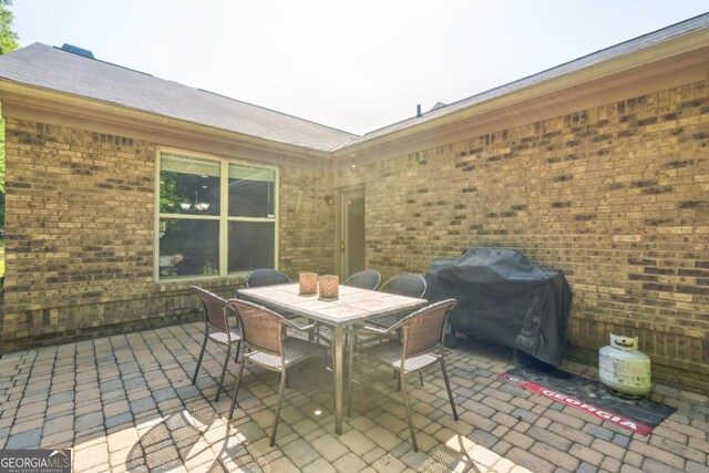 view of patio / terrace featuring area for grilling and outdoor dining area