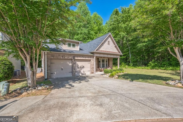 view of front of house featuring concrete driveway, a garage, a front yard, and brick siding