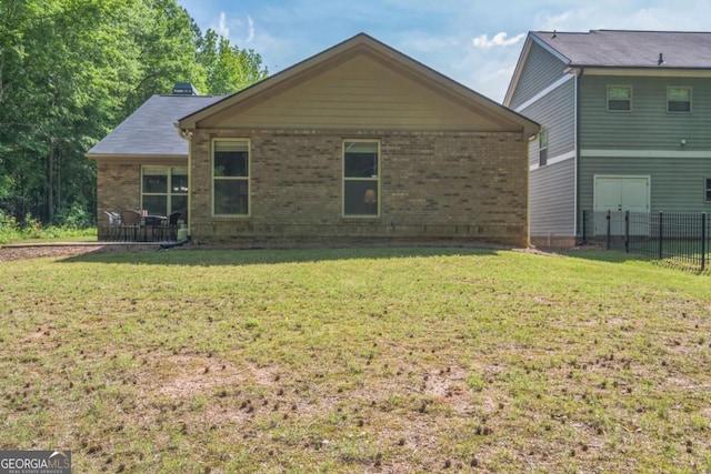 back of property featuring brick siding
