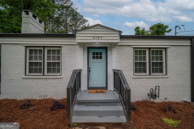 2137 Delowe Dr, Atlanta, GA 30344 - view of front of home with brick siding and a chimney