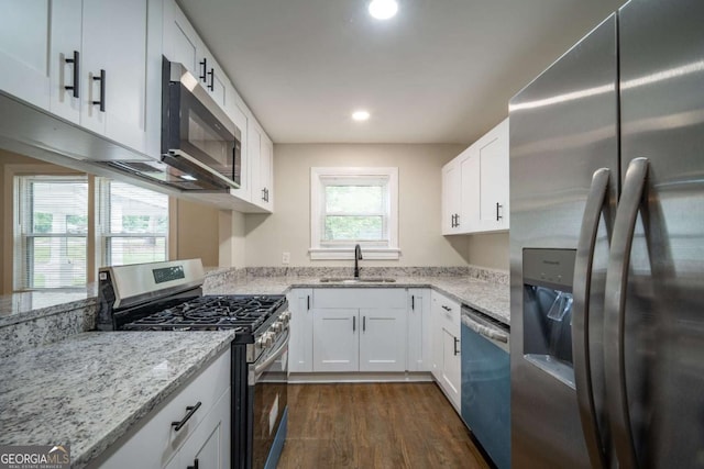 2137 Delowe Dr, Atlanta, GA 30344 - kitchen with appliances with stainless steel finishes, a sink, dark wood finished floors, light stone countertops, and white cabinets
