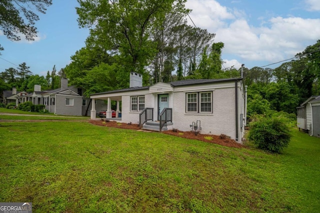 2137 Delowe Dr, Atlanta, GA 30344 - view of front of house with a chimney, a front yard, and brick siding
