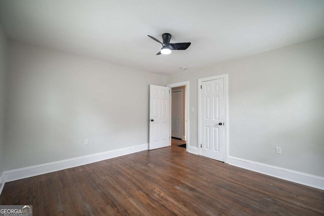 2137 Delowe Dr, Atlanta, GA 30344 - unfurnished bedroom featuring baseboards, dark wood-style floors, a ceiling fan, and a closet