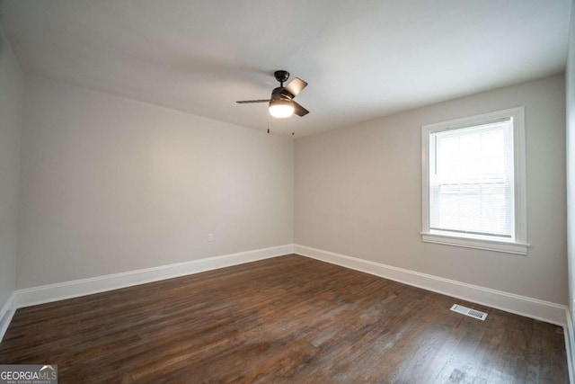 2137 Delowe Dr, Atlanta, GA 30344 - unfurnished room featuring baseboards, a ceiling fan, and dark wood-type flooring