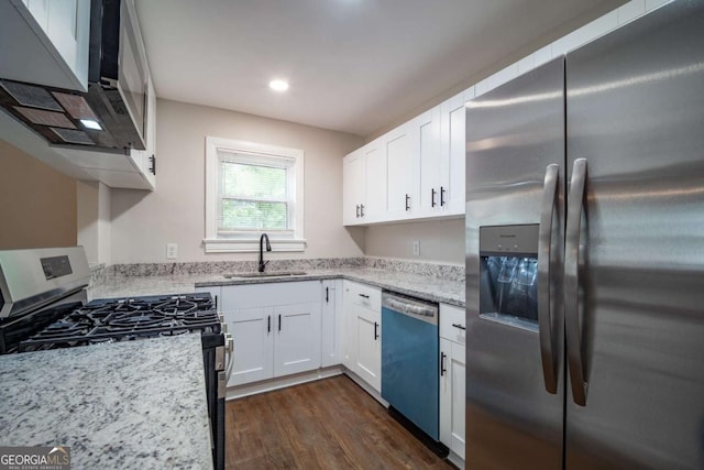 2137 Delowe Dr, Atlanta, GA 30344 - kitchen with stainless steel appliances, a sink, light stone countertops, dark wood-type flooring, and white cabinetry