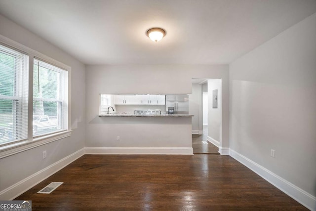 2137 Delowe Dr, Atlanta, GA 30344 - unfurnished living room featuring dark wood finished floors, baseboards, a sink, and electric panel