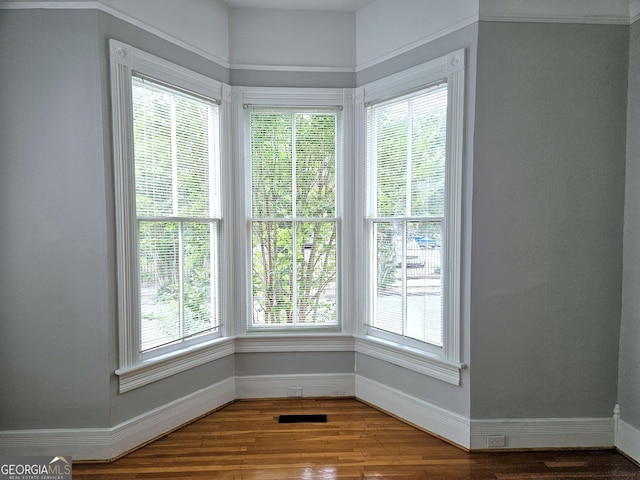 unfurnished room with baseboards and healthy amount of natural light