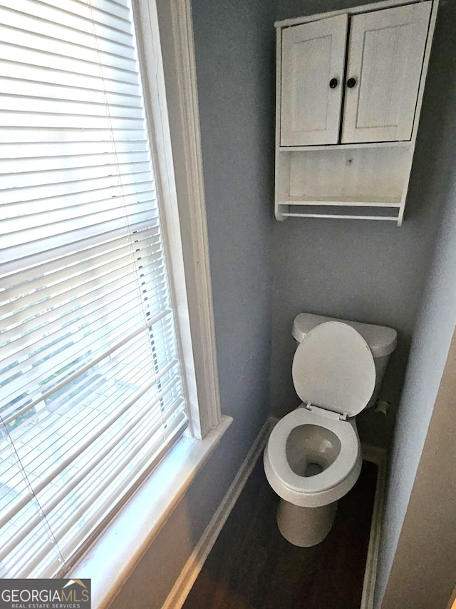 bathroom featuring baseboards and toilet