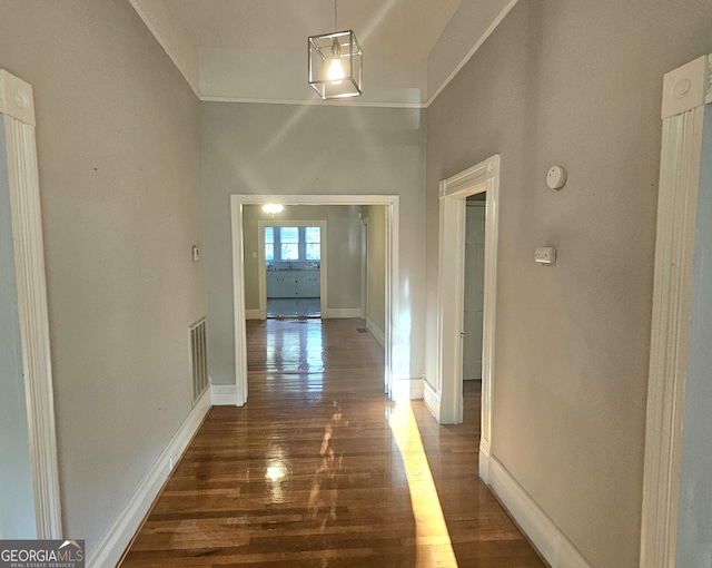 hall with dark wood-type flooring and baseboards