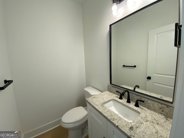 2167 Main St NW, Atlanta, GA 30318 - bathroom featuring vanity, toilet, baseboards, and wood finished floors