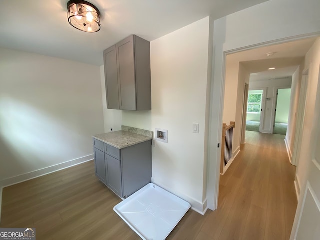 2167 Main St NW, Atlanta, GA 30318 - laundry room featuring baseboards, hookup for a washing machine, cabinet space, and wood finished floors