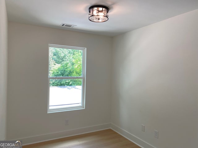 2167 Main St NW, Atlanta, GA 30318 - empty room featuring light wood-type flooring, baseboards, visible vents, and plenty of natural light