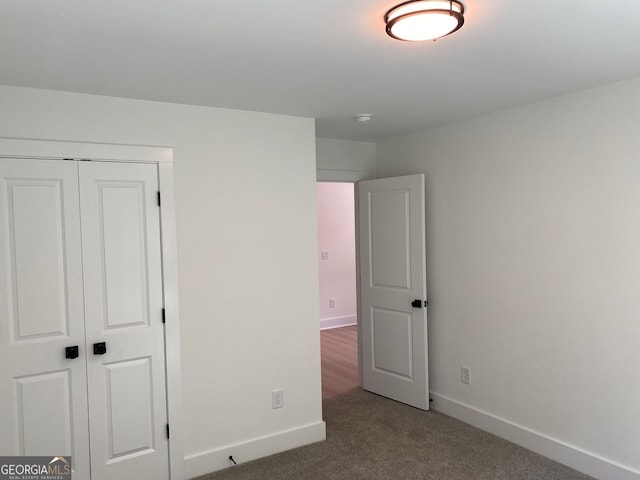 2167 Main St NW, Atlanta, GA 30318 - unfurnished bedroom featuring a closet, baseboards, and carpet floors