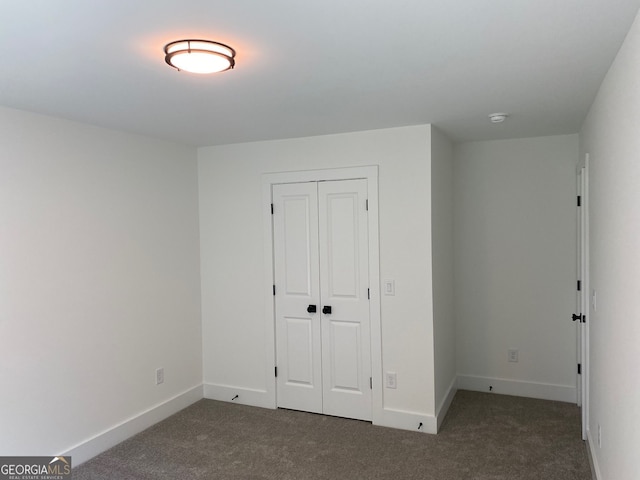 2167 Main St NW, Atlanta, GA 30318 - unfurnished bedroom featuring carpet flooring, a closet, and baseboards