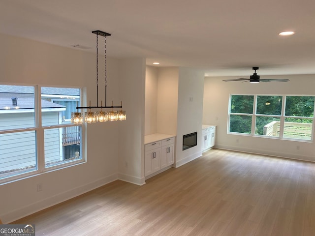 2167 Main St NW, Atlanta, GA 30318 - unfurnished living room with recessed lighting, ceiling fan with notable chandelier, baseboards, and light wood-style floors