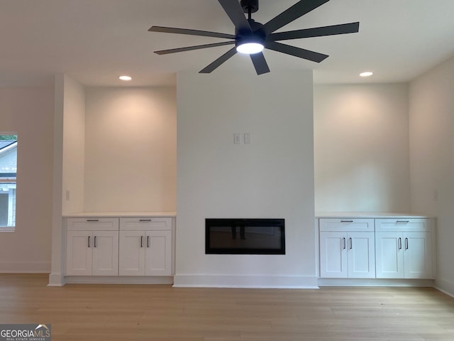 2167 Main St NW, Atlanta, GA 30318 - unfurnished living room with light wood finished floors, a glass covered fireplace, and recessed lighting