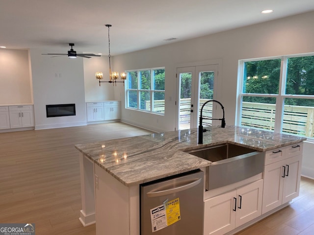 2167 Main St NW, Atlanta, GA 30318 - kitchen with a sink, stainless steel dishwasher, visible vents, light wood-style floors, and light stone counters