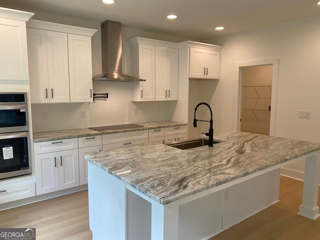 2167 Main St NW, Atlanta, GA 30318 - kitchen with recessed lighting, wall chimney range hood, white cabinetry, and a sink