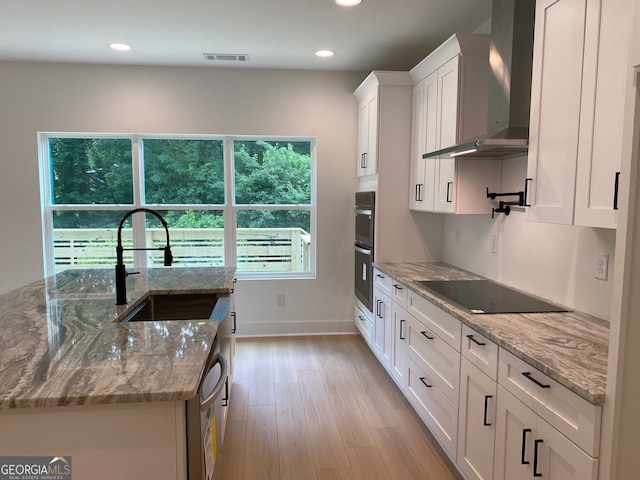2167 Main St NW, Atlanta, GA 30318 - kitchen with visible vents, a sink, white cabinetry, wall chimney exhaust hood, and black electric stovetop