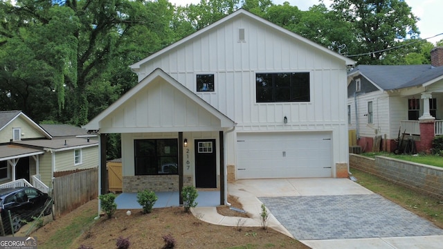 2167 Main St NW, Atlanta, GA 30318 - view of front of home with board and batten siding, driveway, fence, covered porch, and a garage