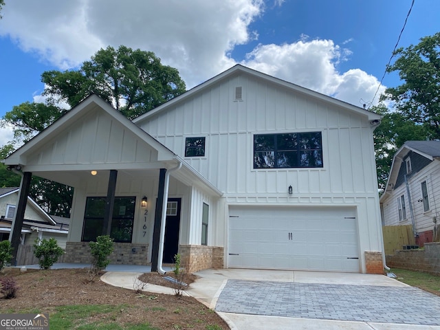 2167 Main St NW, Atlanta, GA 30318 - modern farmhouse with board and batten siding, driveway, brick siding, covered porch, and a garage