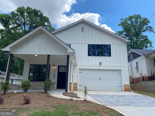 2167 Main St NW, Atlanta, GA 30318 - modern farmhouse with board and batten siding, a porch, a garage, and driveway