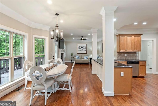 dining room with ornamental molding, a ceiling fan, wood finished floors, a fireplace, and recessed lighting