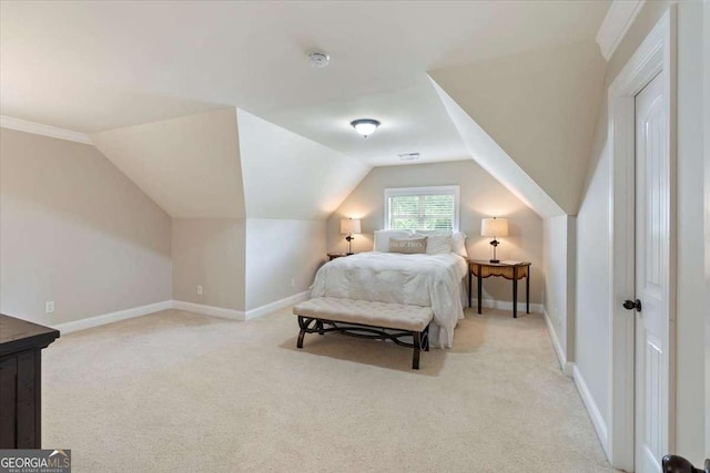 bedroom featuring light carpet, lofted ceiling, and baseboards