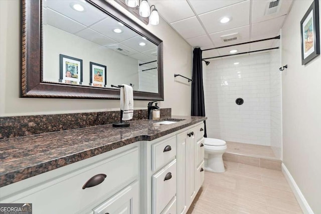 full bathroom with toilet, recessed lighting, tiled shower, vanity, and tile patterned floors