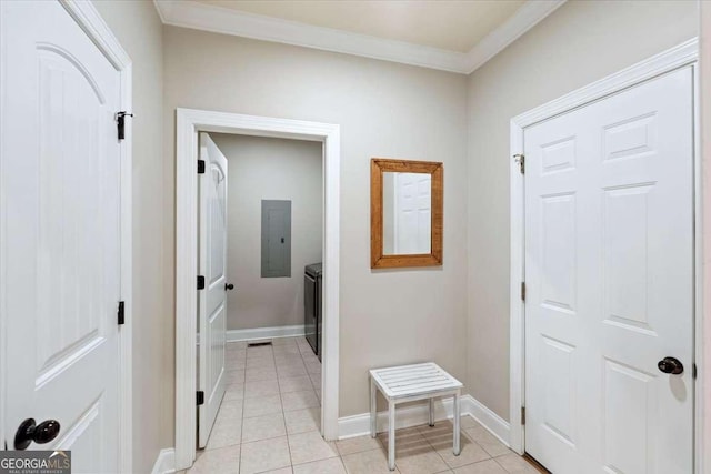 hall with electric panel, ornamental molding, light tile patterned floors, baseboards, and independent washer and dryer