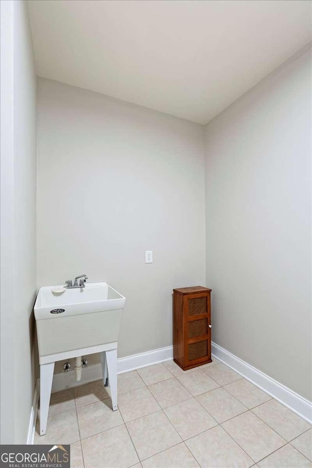 bathroom with baseboards and tile patterned floors