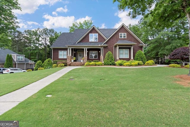 craftsman-style home with a front yard and a porch