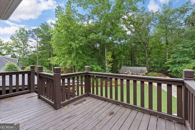 deck featuring a yard and an outdoor structure