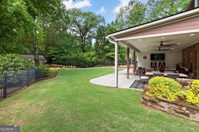 view of yard featuring an outdoor living space, a patio, and a ceiling fan