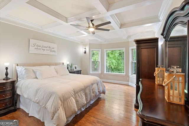 bedroom with beam ceiling, wood finished floors, coffered ceiling, baseboards, and a ceiling fan