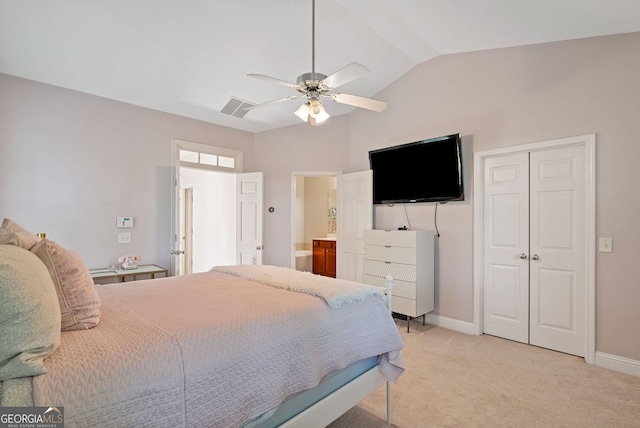 bedroom with a ceiling fan, a closet, light carpet, baseboards, and vaulted ceiling