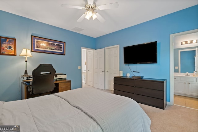 carpeted bedroom with ceiling fan, connected bathroom, and visible vents
