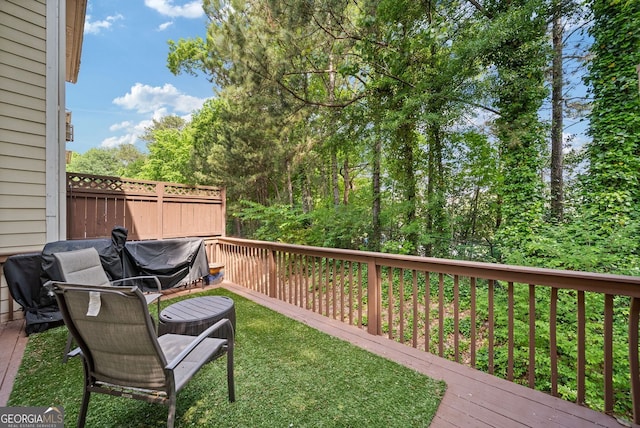 wooden deck with a lawn