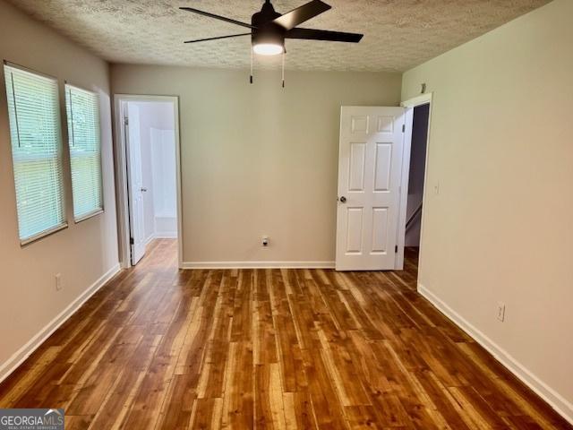 3988 Chimney Ridge Dr, Ellenwood, GA 30294 - spare room featuring a ceiling fan, baseboards, a textured ceiling, and wood finished floors
