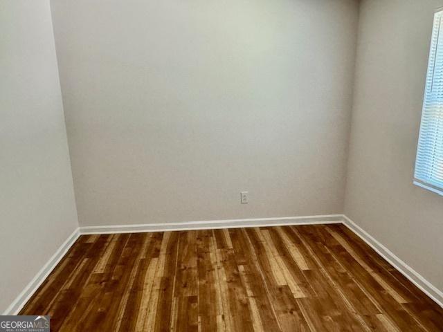 3988 Chimney Ridge Dr, Ellenwood, GA 30294 - unfurnished room with baseboards and dark wood-type flooring