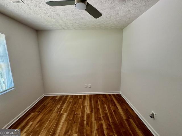 3988 Chimney Ridge Dr, Ellenwood, GA 30294 - empty room with a textured ceiling, wood finished floors, baseboards, and ceiling fan