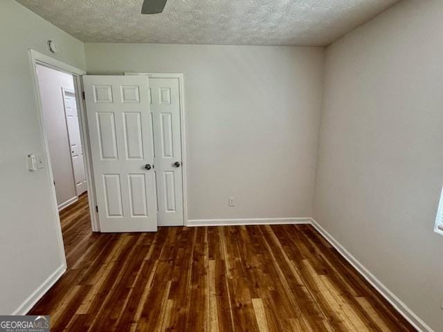 3988 Chimney Ridge Dr, Ellenwood, GA 30294 - unfurnished bedroom with a textured ceiling, baseboards, and wood finished floors