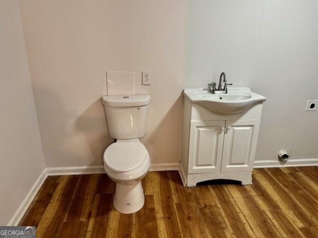 3988 Chimney Ridge Dr, Ellenwood, GA 30294 - bathroom featuring toilet, baseboards, wood finished floors, and vanity