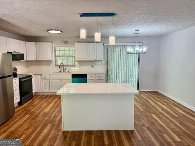 3988 Chimney Ridge Dr, Ellenwood, GA 30294 - kitchen with a sink, stainless steel appliances, a textured ceiling, and white cabinets